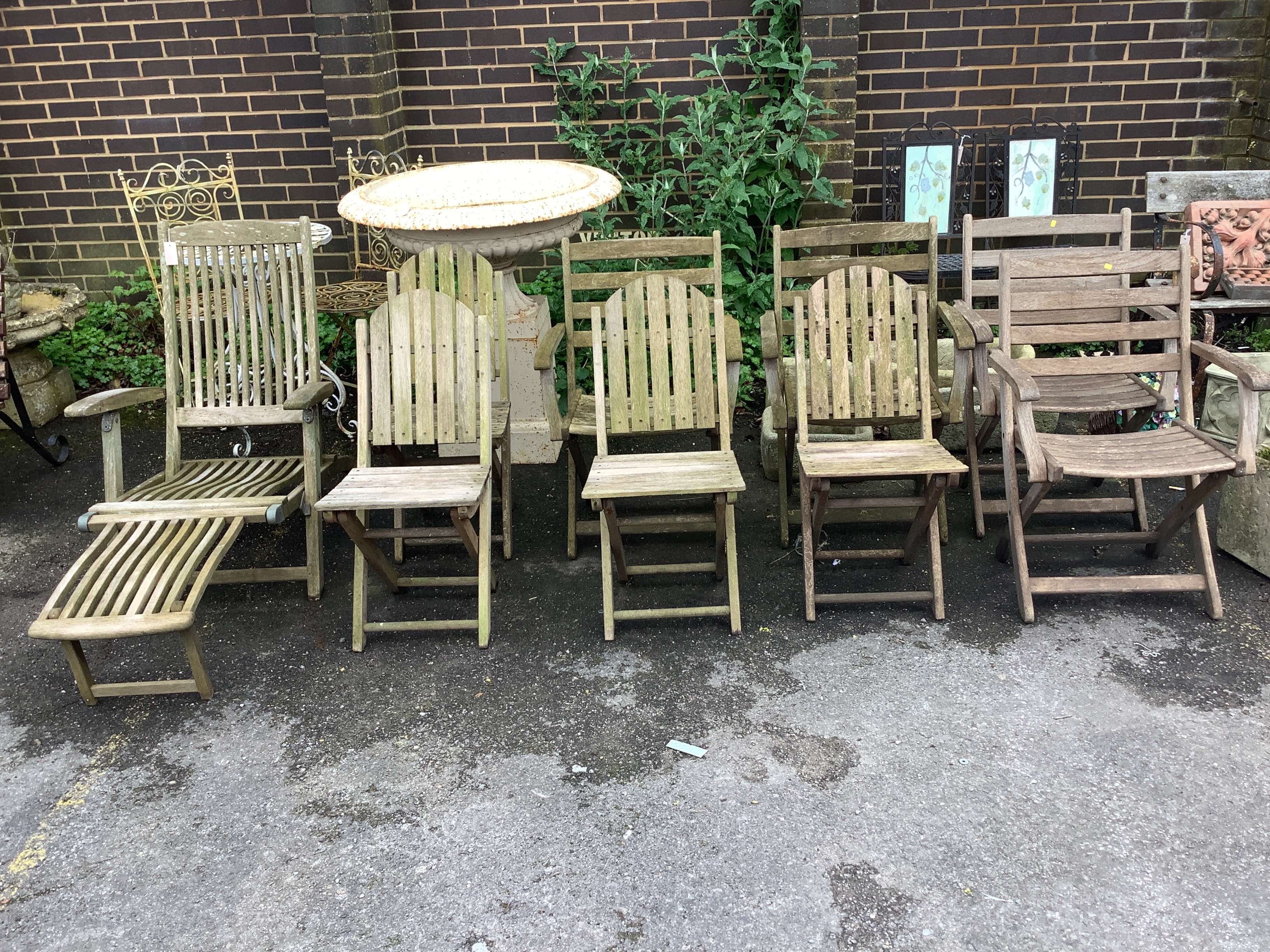 A set of four Alexander Rose teak folding garden elbow chairs, an Alexander Rose teak steamer chair and four other teak folding garden chairs